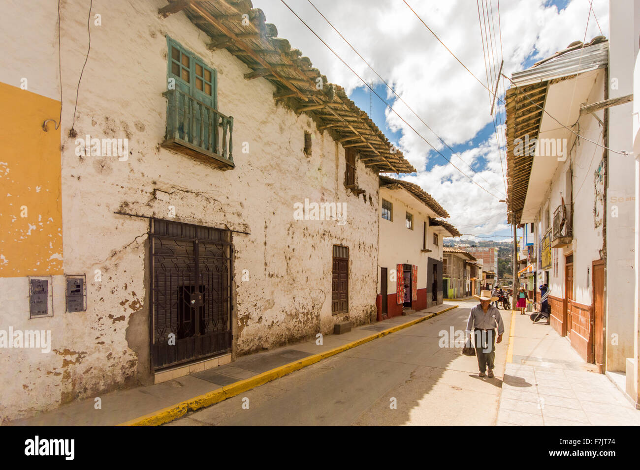 Traditionally dressed Peruvian man walks through old colonial street of town of Cajabamba in Cajamarca region of Peru Stock Photo