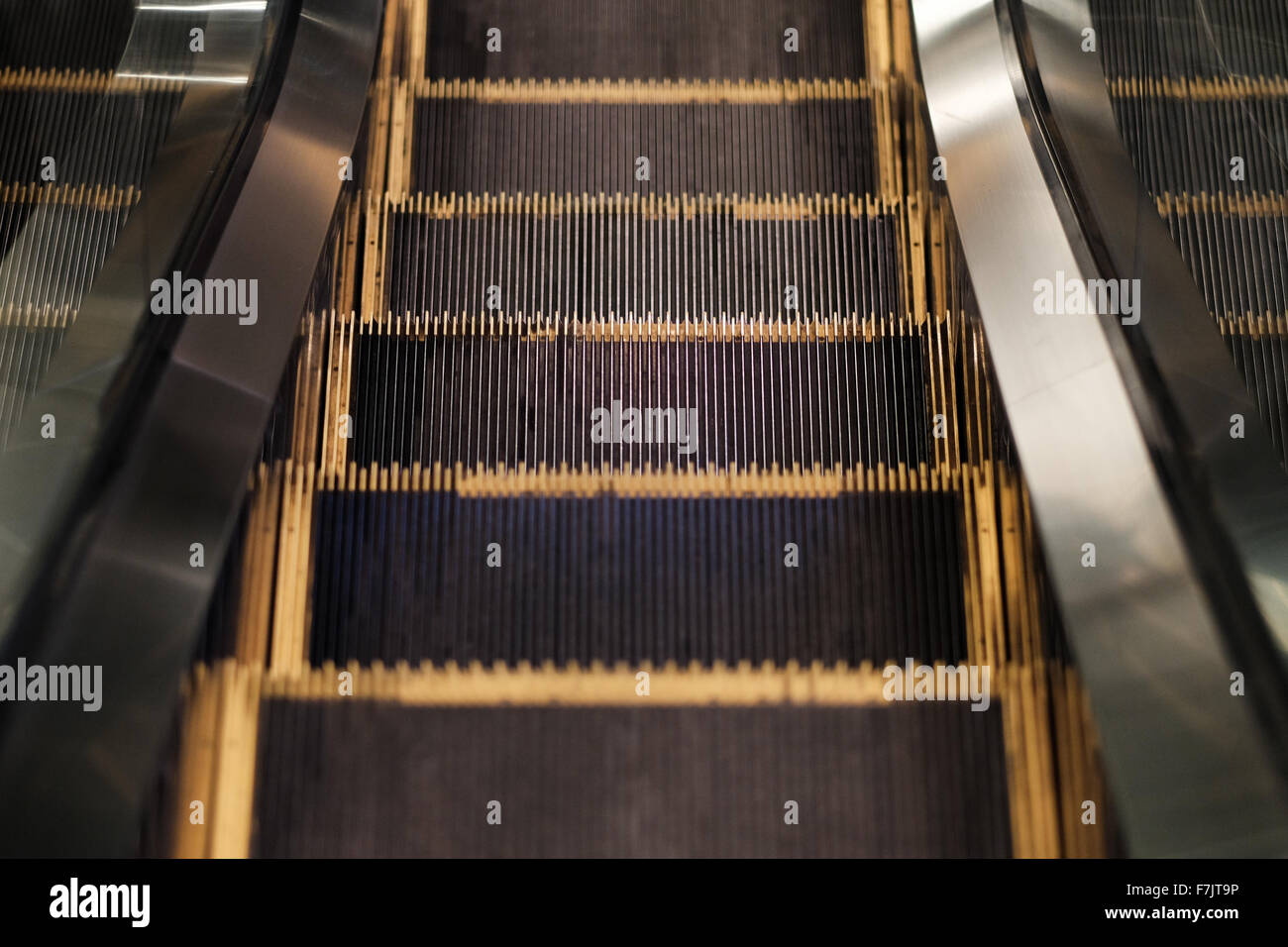 Downward escalator steps Stock Photo