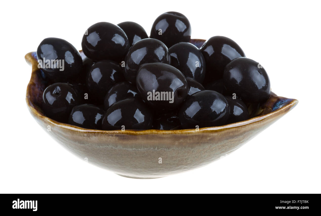 Olives black watered with olive oil in a bowl isolated on a white ...