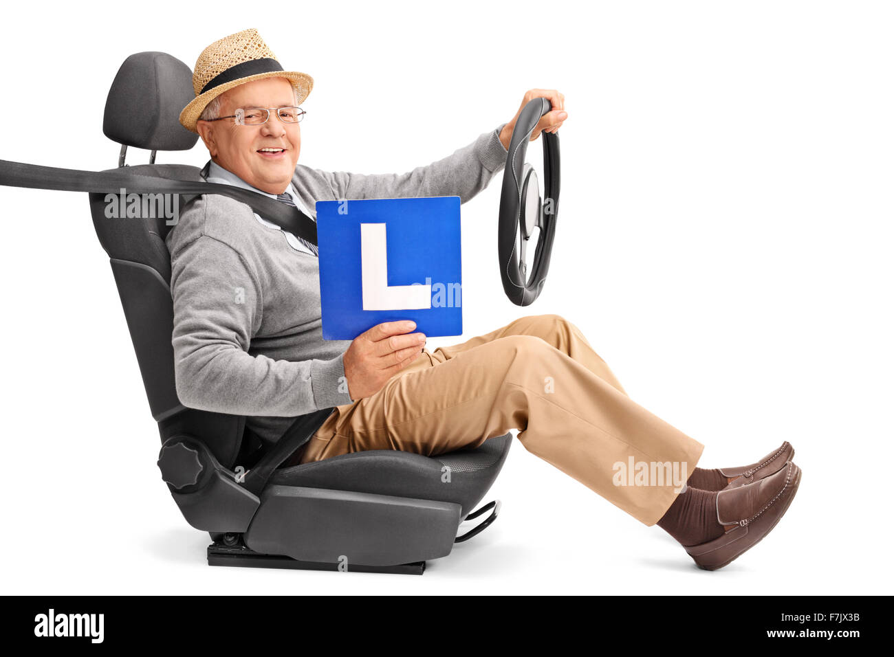 Senior gentleman sitting on a car seat and holding an L-sign isolated on white background Stock Photo