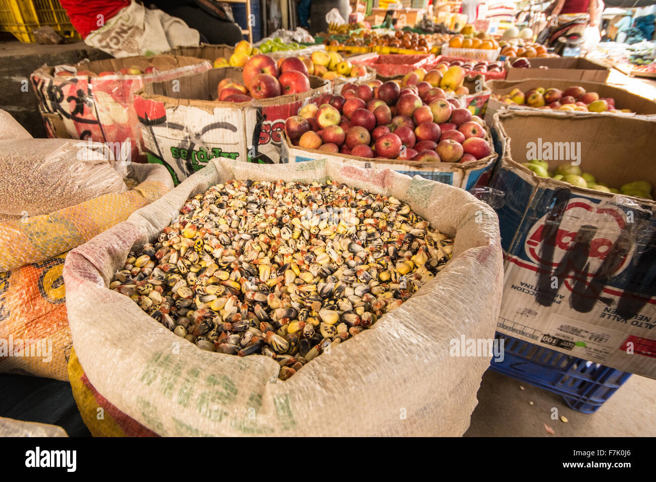 Sack of multicolored corn and other fresh produce on sale in street
