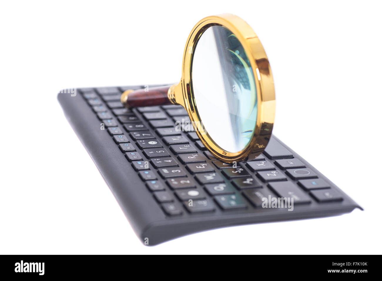Magnifying Glass on black keyboard isolated Stock Photo Alamy
