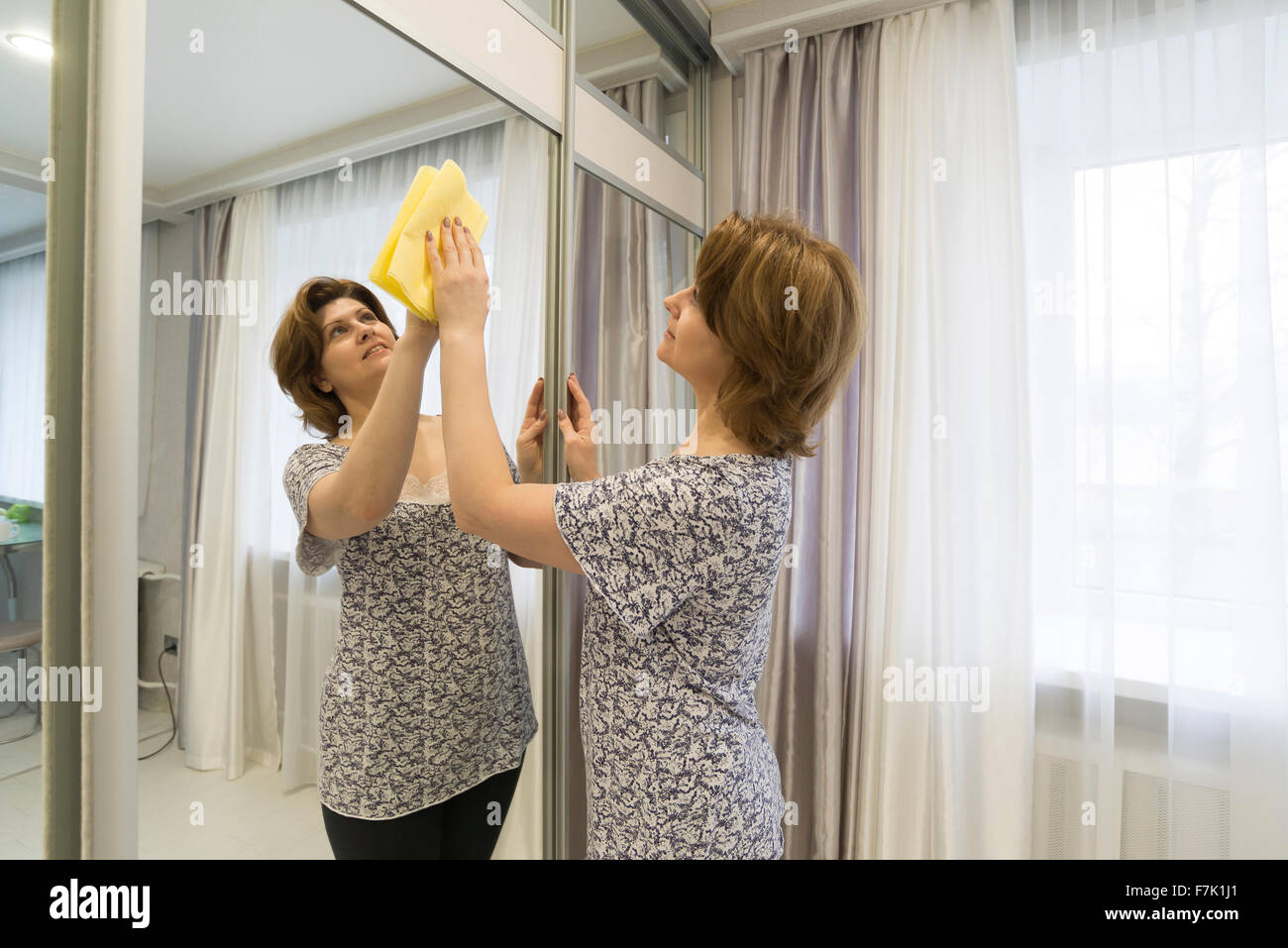 Woman polishes a cloth mirror box Stock Photo