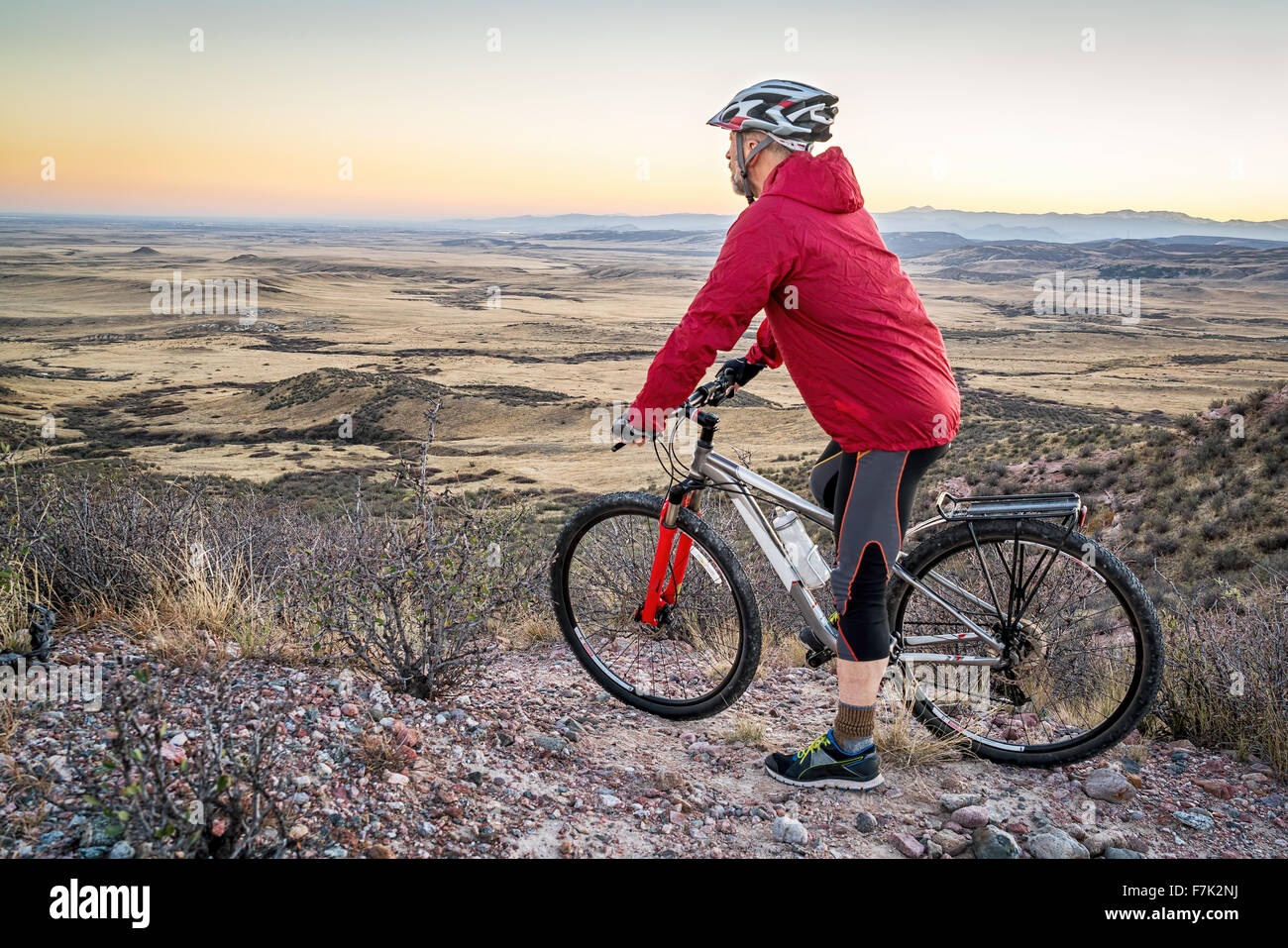 senior male with a mountain contemplating  dusk over rolling prairie,  Soapstone Prairie Natural Area near Fort Collins Stock Photo