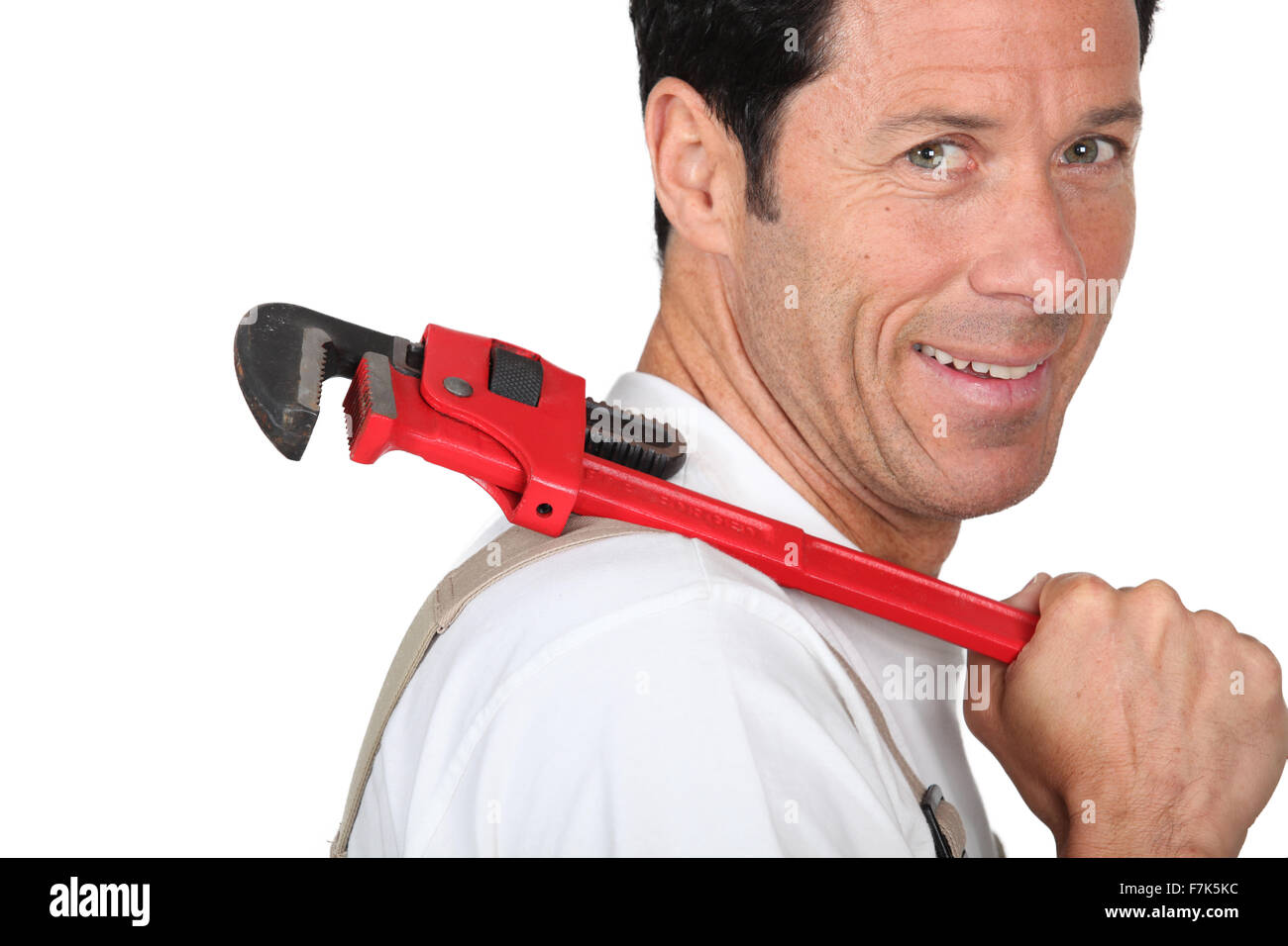 Plumber holding wrench over shoulder Stock Photo Alamy
