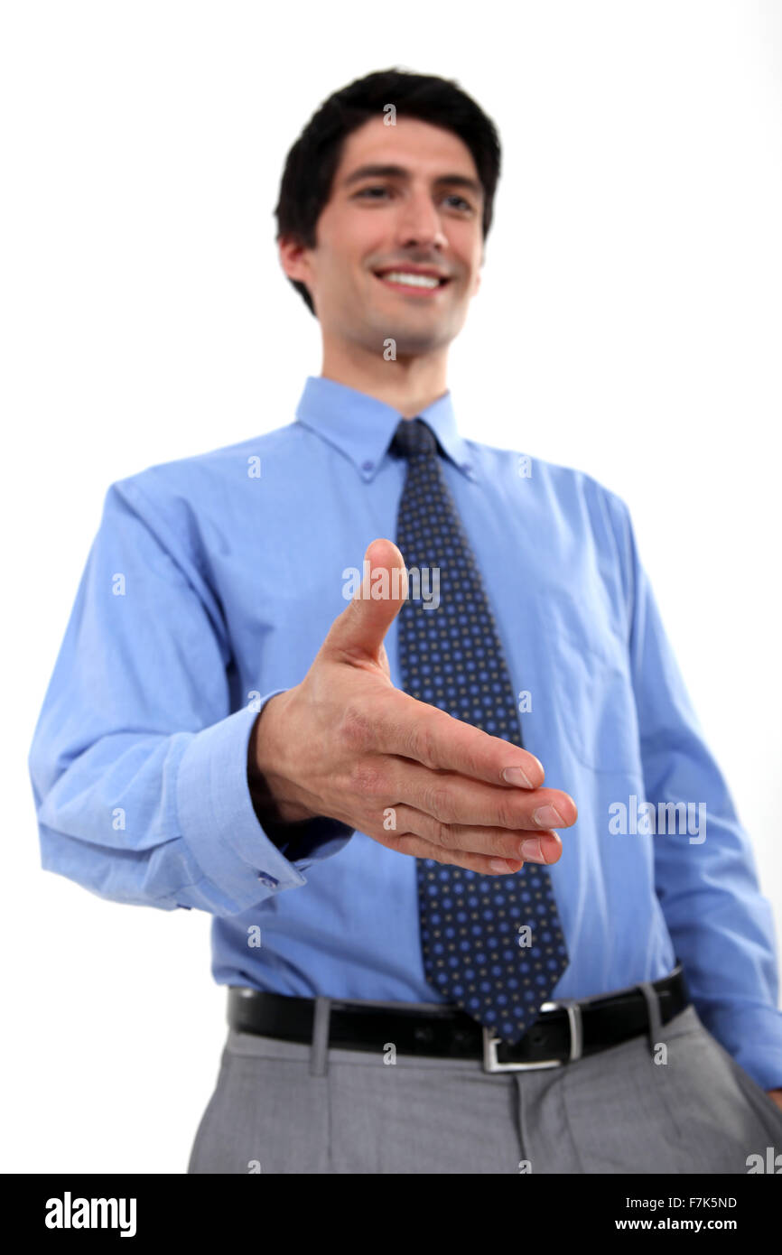 Hand Out Hand In Businessman holding hand out Stock Photo - Alamy