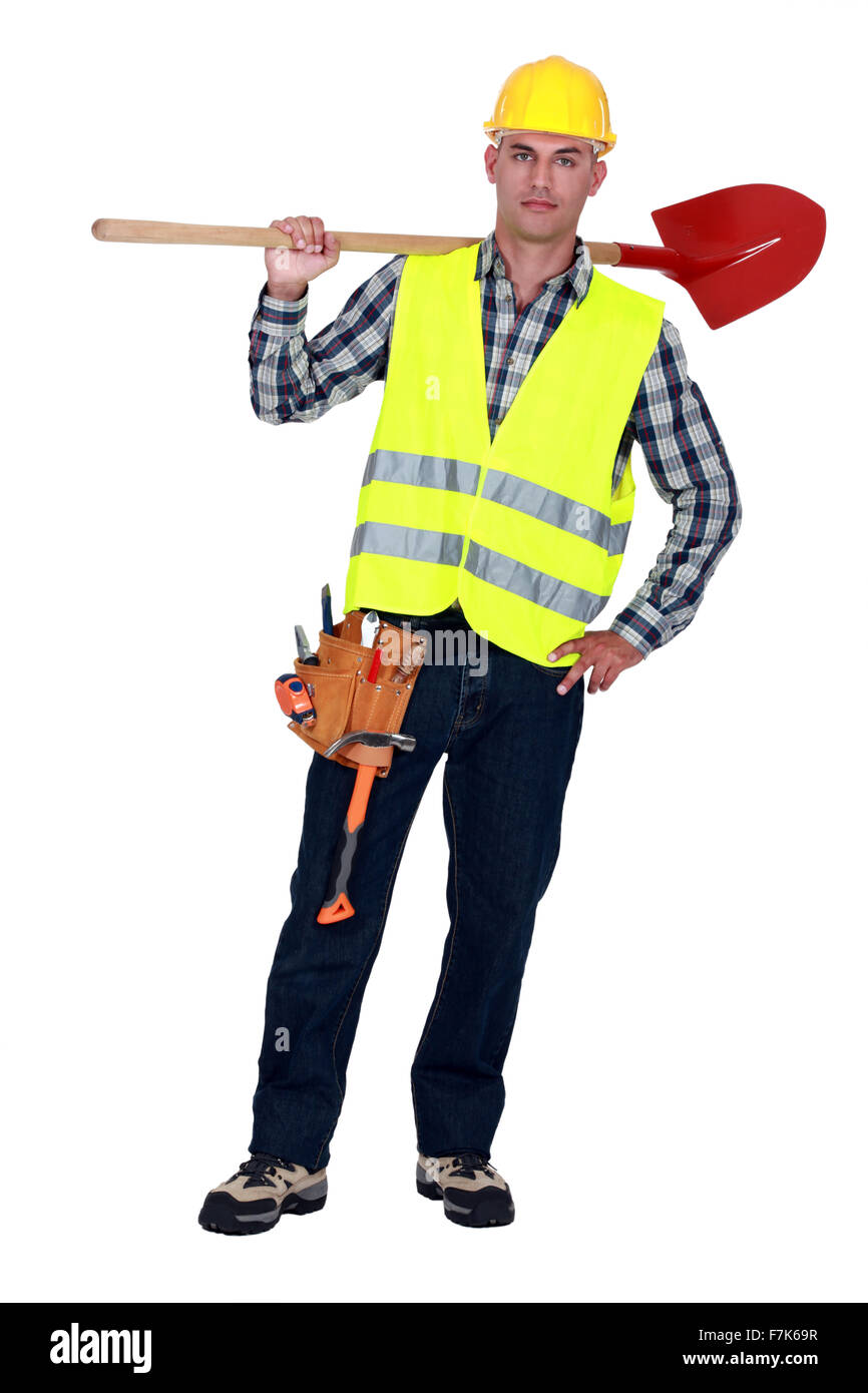 Labourer carrying a spade Stock Photo Alamy