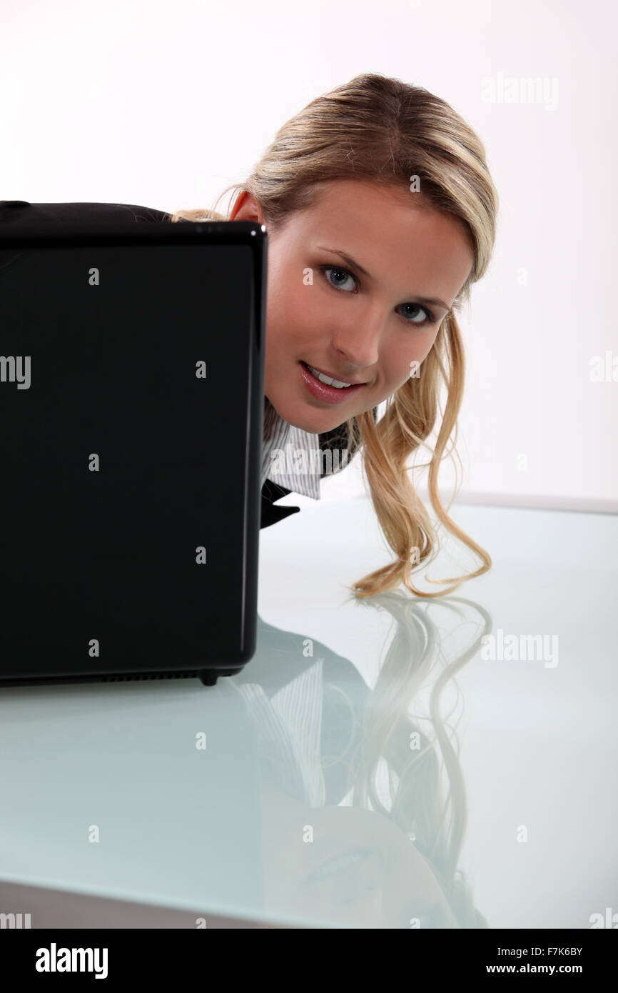 Woman Head Over Computer Screen Woman peering around her laptop Stock Photo - Alamy