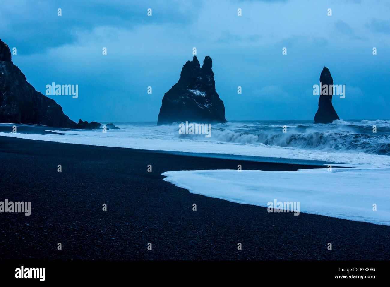 Rock formations and stormy ocean at dusk, Reynisdrangar, Vik, Iceland Stock Photo