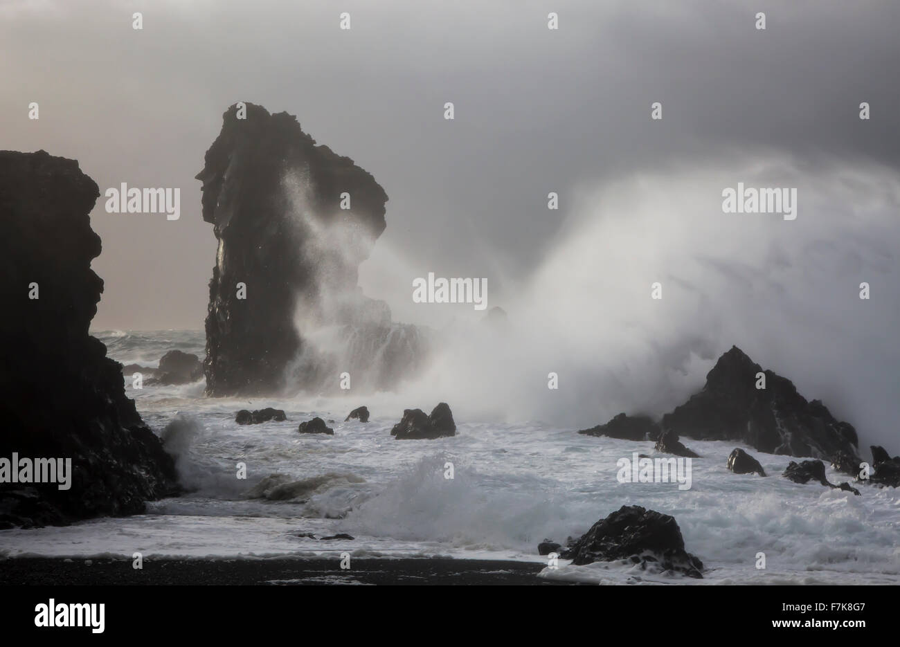 Ocean waves crashing against rock formations, Londrangar, Snaefellsnes, Iceland Stock Photo