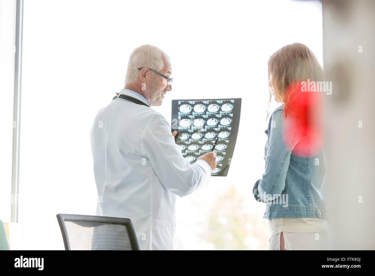 Doctor reviewing xrays with patient in doctor’s office Stock Photo Alamy