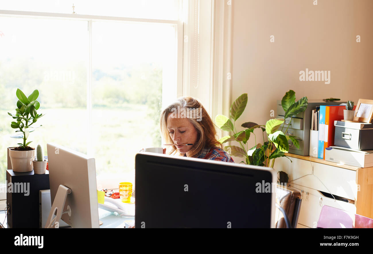 Focused woman working in home office Stock Photo