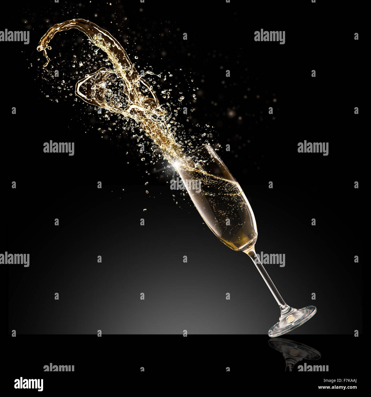 Glass of champagne with splash, isolated on black Stock Photo