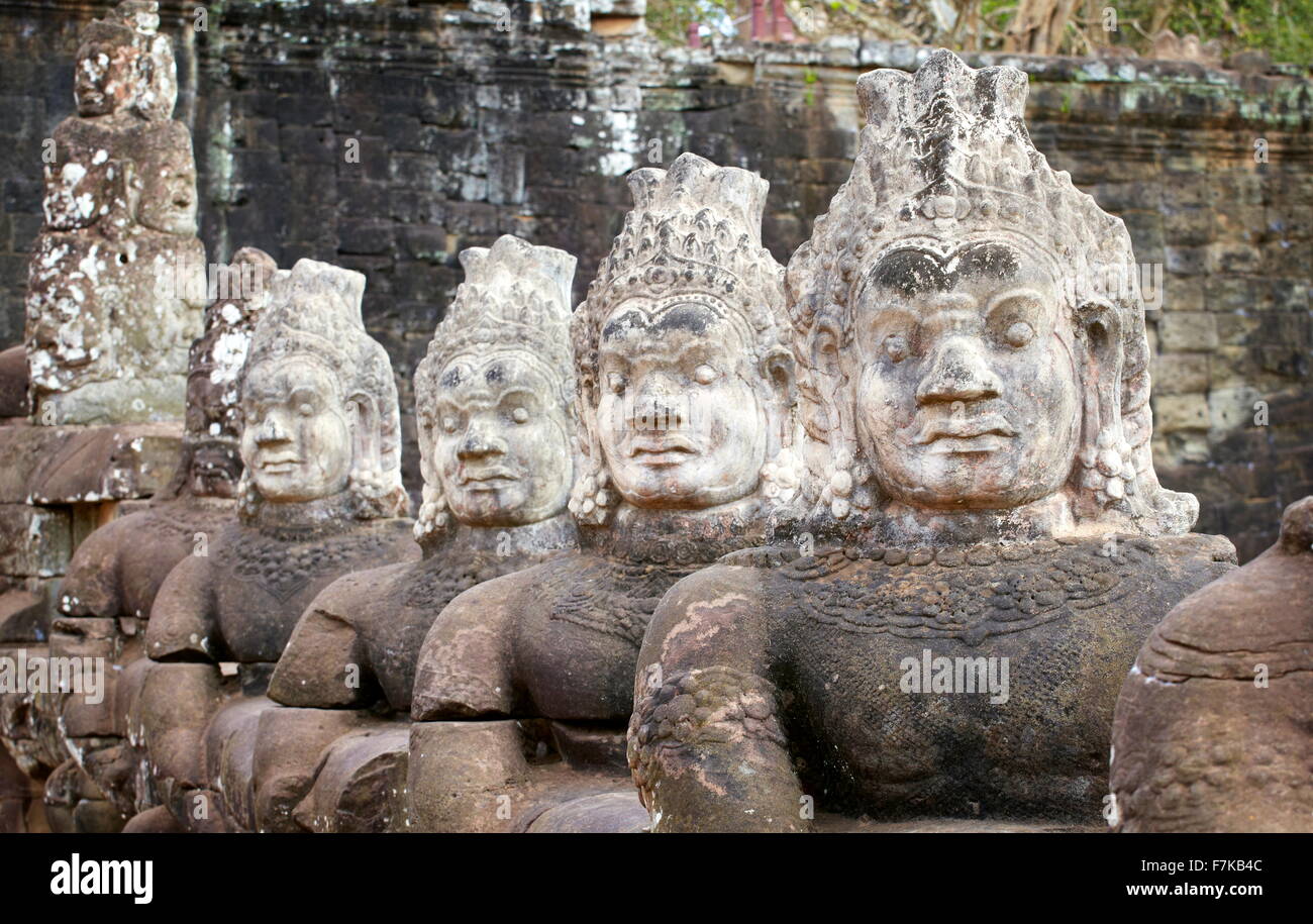 Stone faces on the bridge at the south gate of Angkor Thom, Cambodia, Asia Stock Photo
