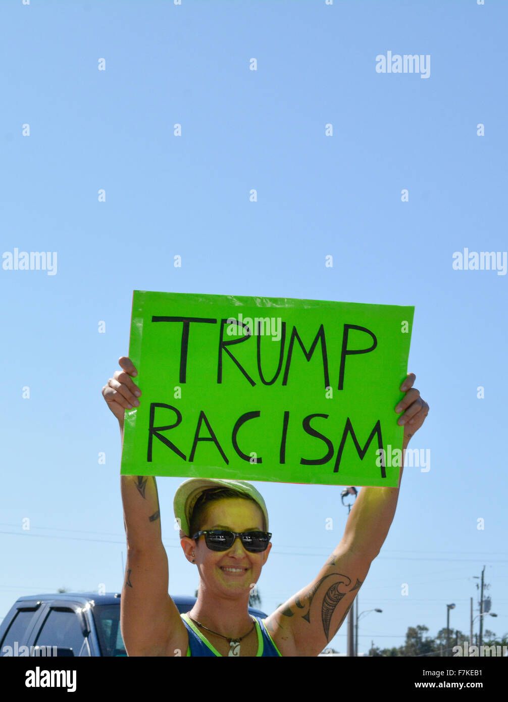 Female protester holding sign denouncing Donald Trump reads TRUMP ...