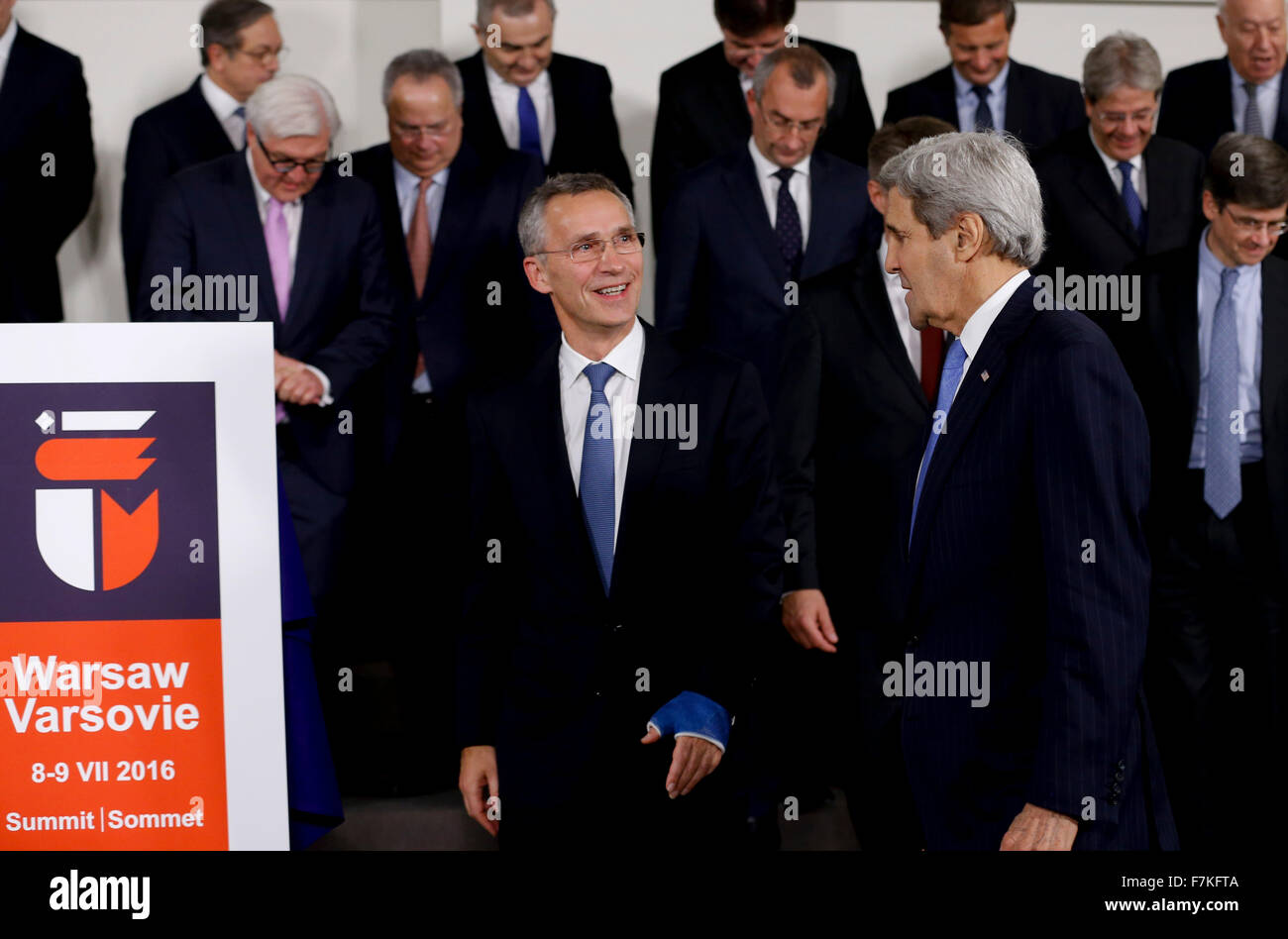 (151201)-- BRUSSELS, Dec. 1, 2015 (Xinhua) -- NATO Secretary General Jens Stoltenberg (L, front) talks with U.S. Secretary of State John Kerry (R, front) as they walk past the logo for the upcoming NATO summit 2016 at a group photo session during NATO foreign ministers meetings at its headquarters in Brussels, Belgium, Dec. 1, 2015. (Xinhua/Ye Pingfan) Stock Photo