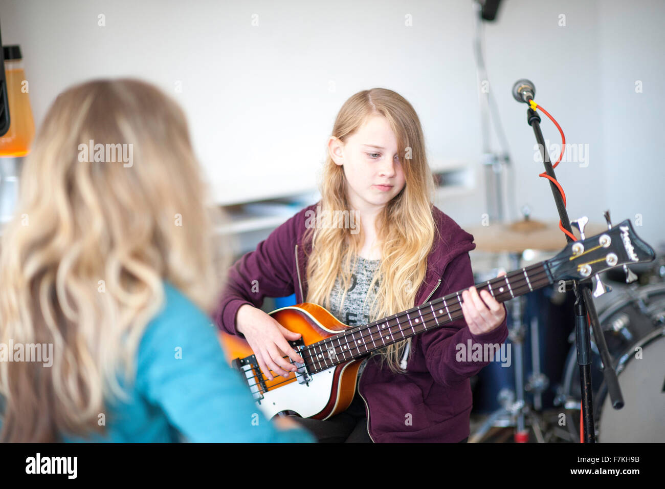 A young girl learning to play guitar Stock Photo