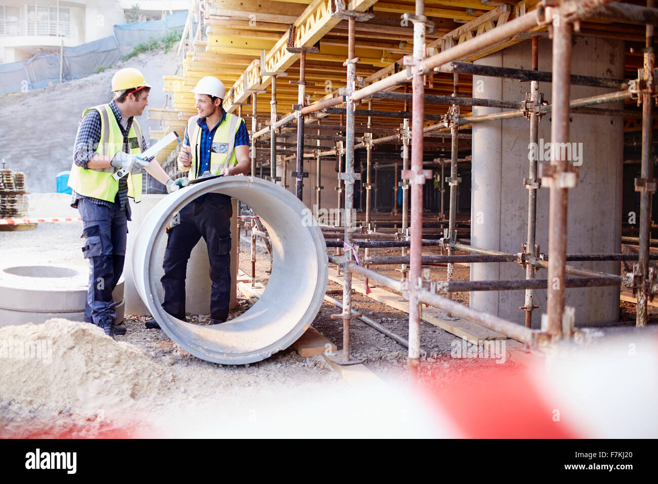 Construction workers talking at construction site Stock Photo