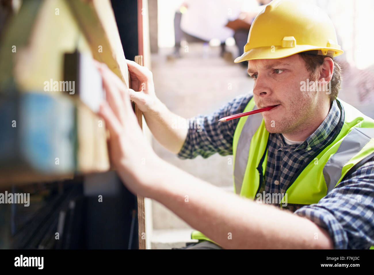 Construction worker using level tool Stock Photo