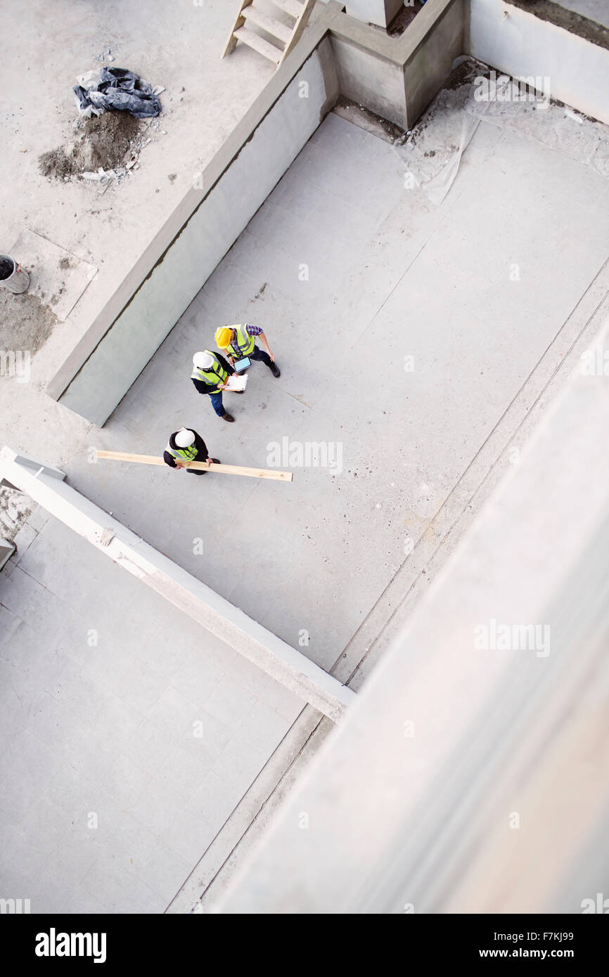 Overhead view of construction workers at construction site Stock Photo