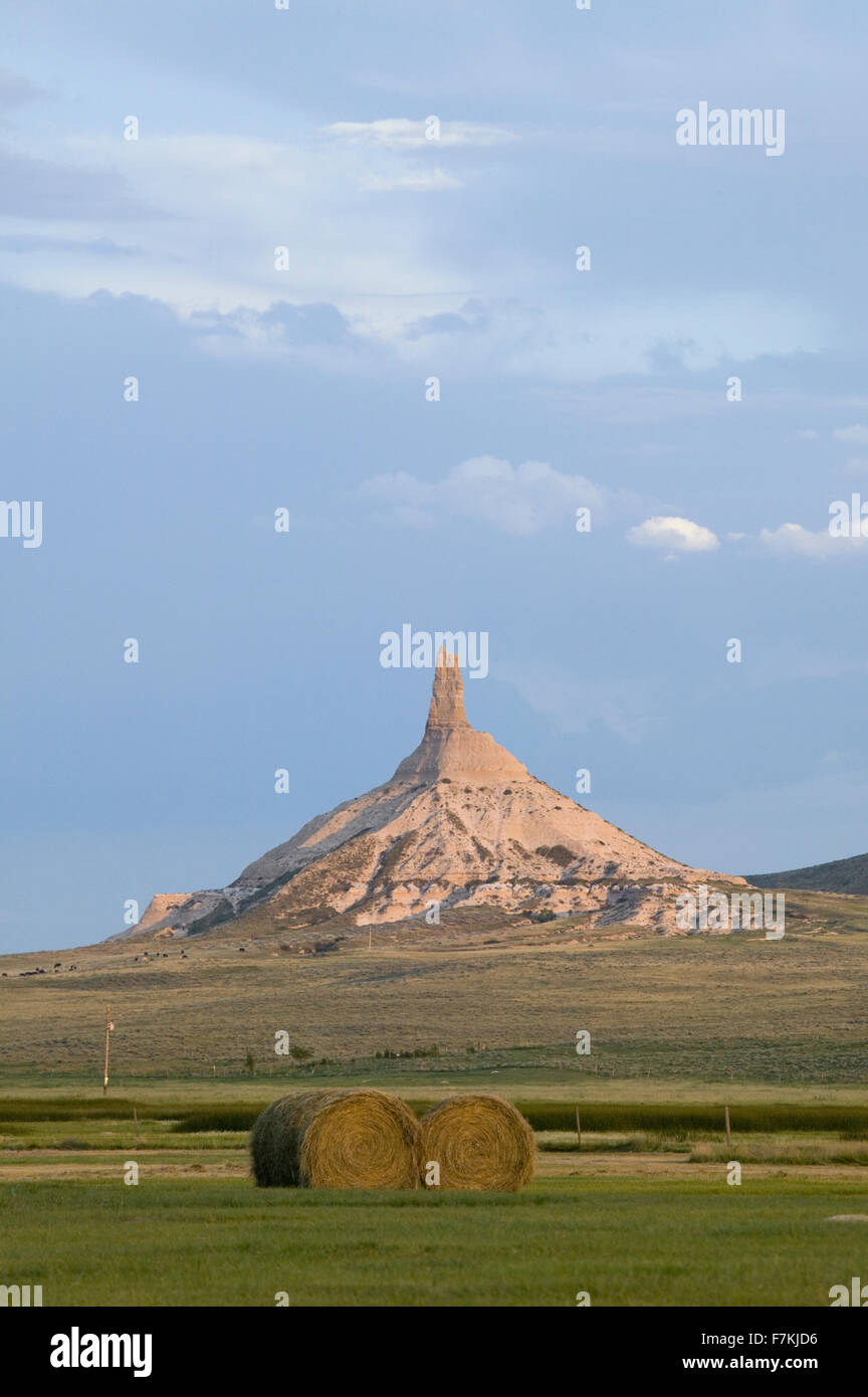 Hay bails in front of Chimney Rock National Historic Site, Nebraska, the most famous site on the Oregon Trail for early settlers and pioneers Stock Photo