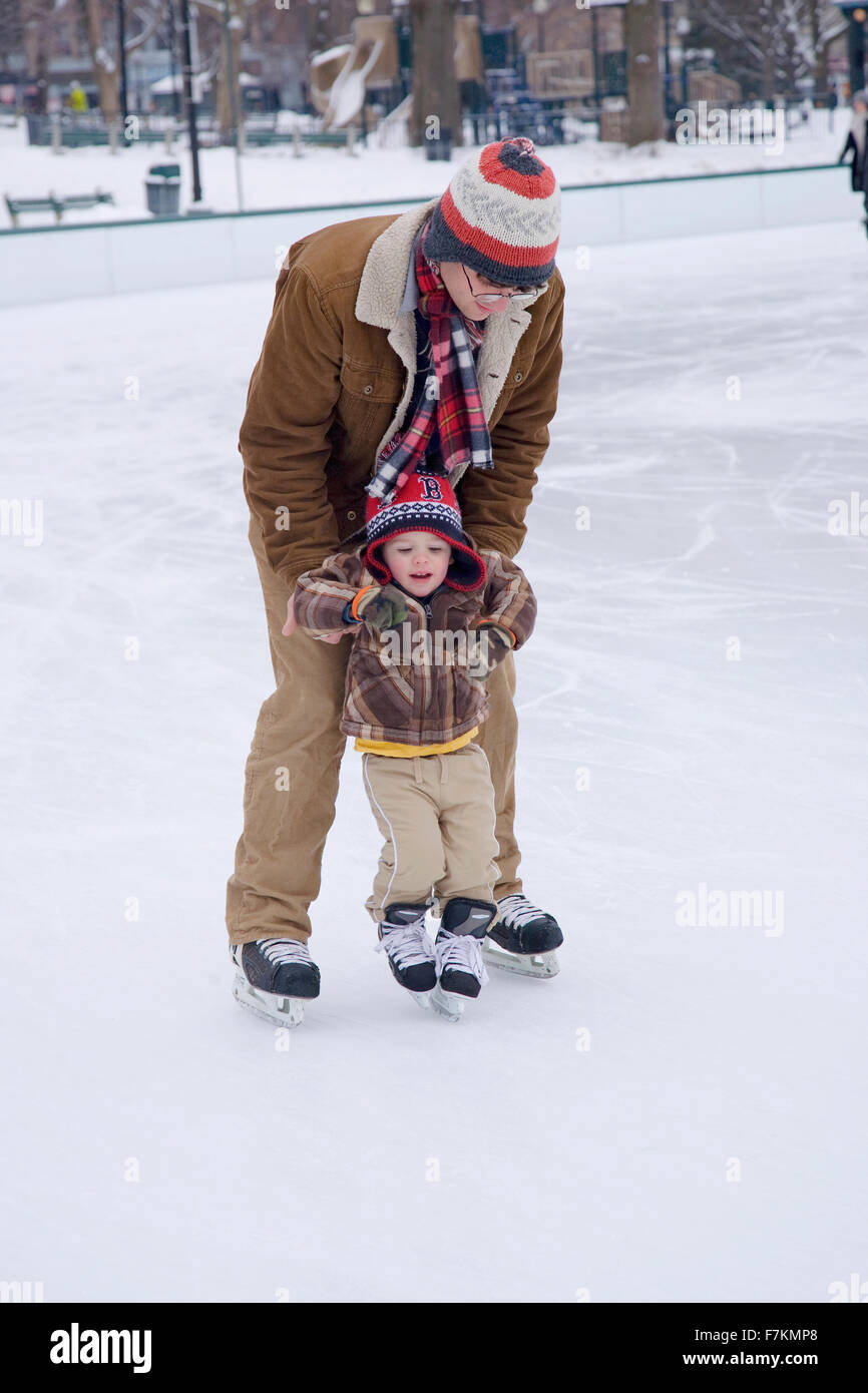 Father teaches son to skate at Boston Common Ice Skating Rink and Frog