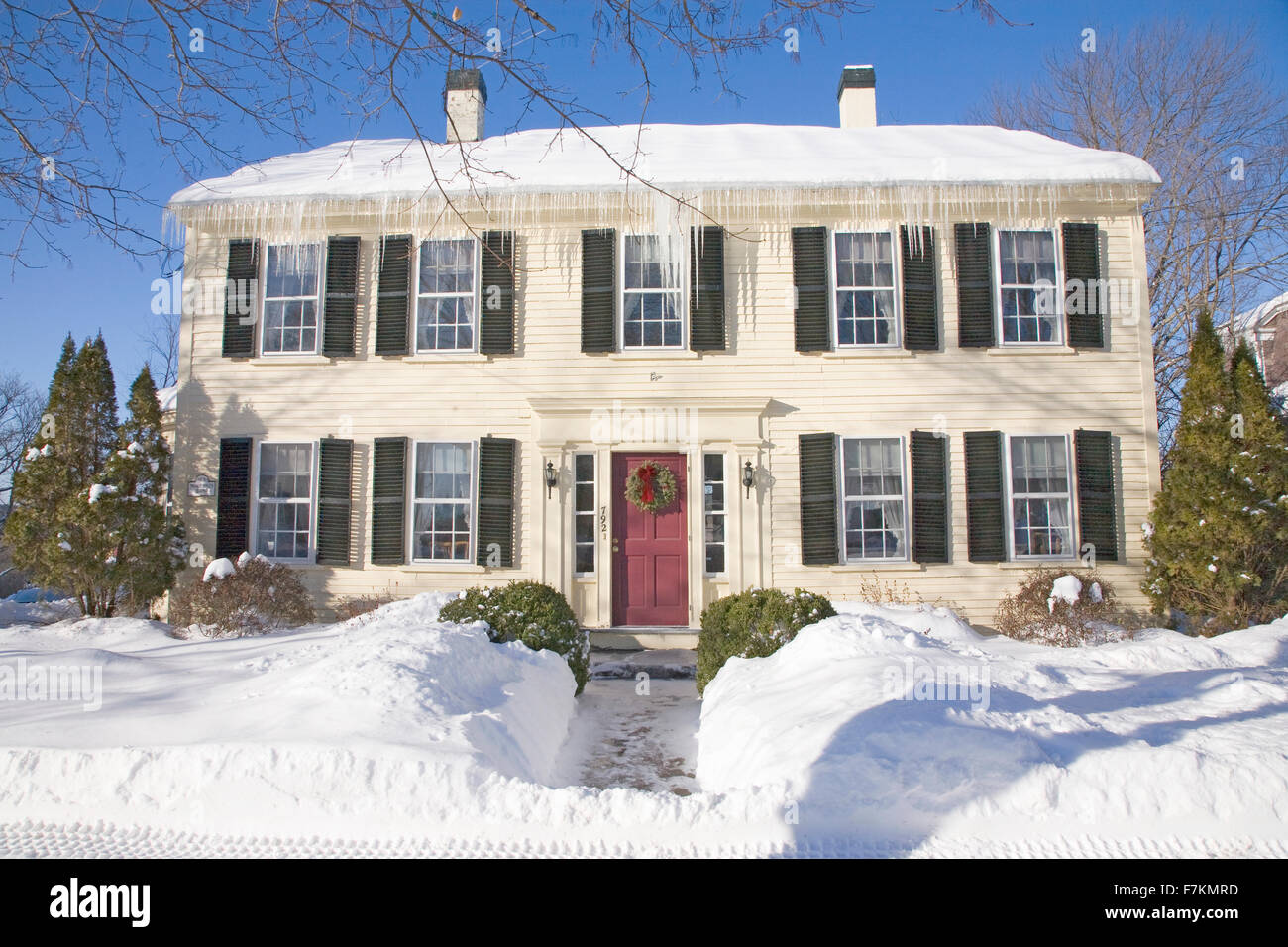 New England home with fresh snow and ice cycles, MA., USA Stock Photo