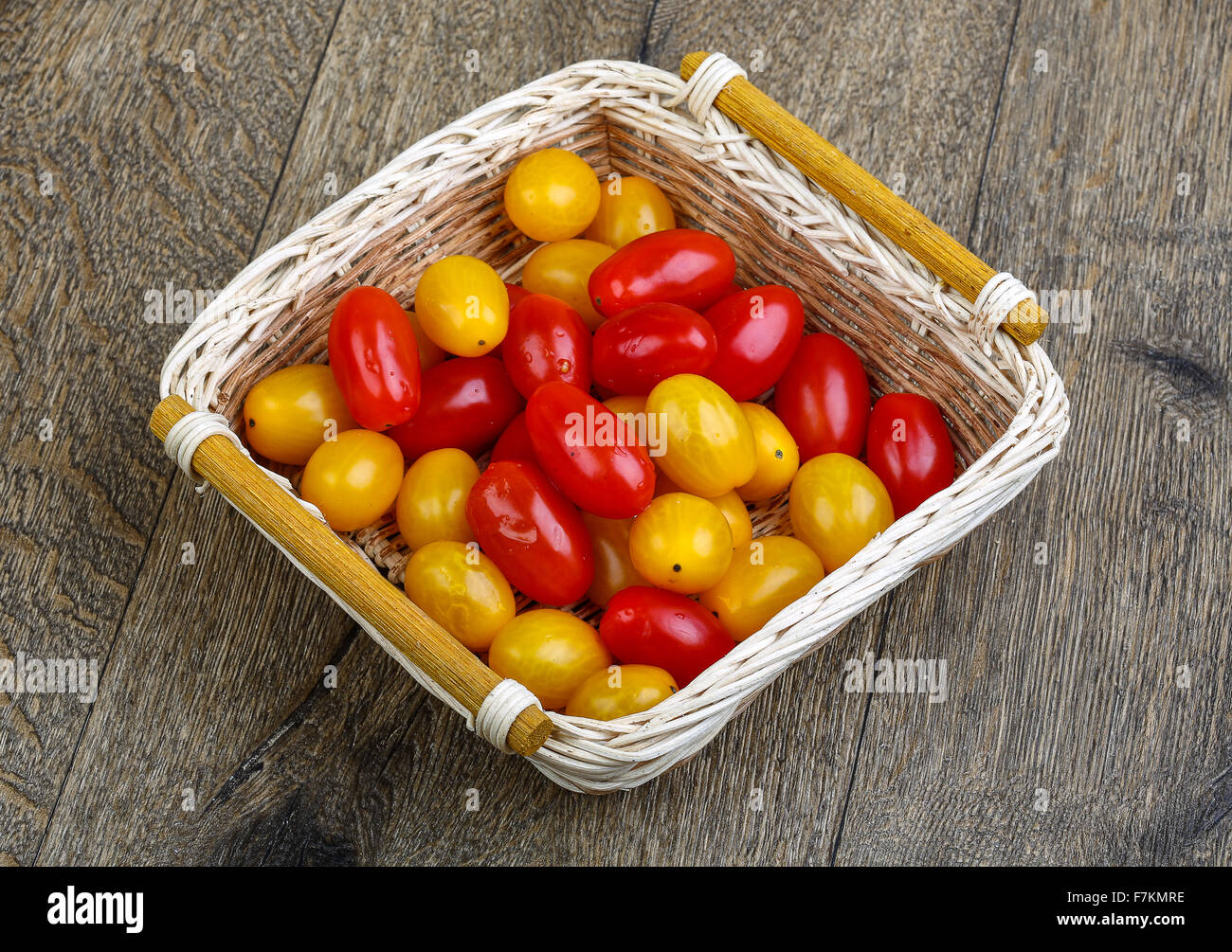 Yellow and red cherry tomatoes mix on the basket Stock Photo - Alamy