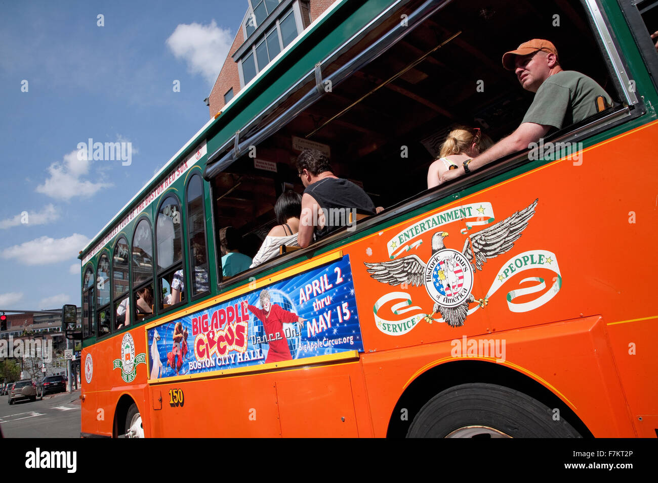 Bright Orange Tour Bus drives to historic sites of Boston, MA. Stock Photo