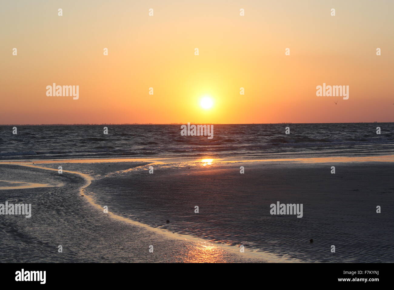 Waves and sand at sunset hi-res stock photography and images - Alamy