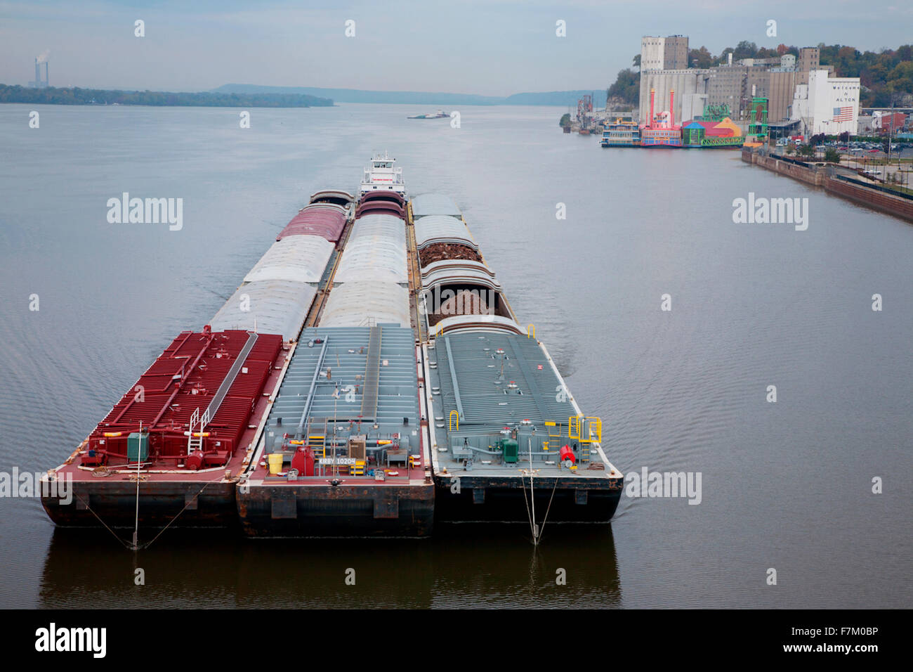 A river barge passes by Alton, Illinois down the Mississippi River and