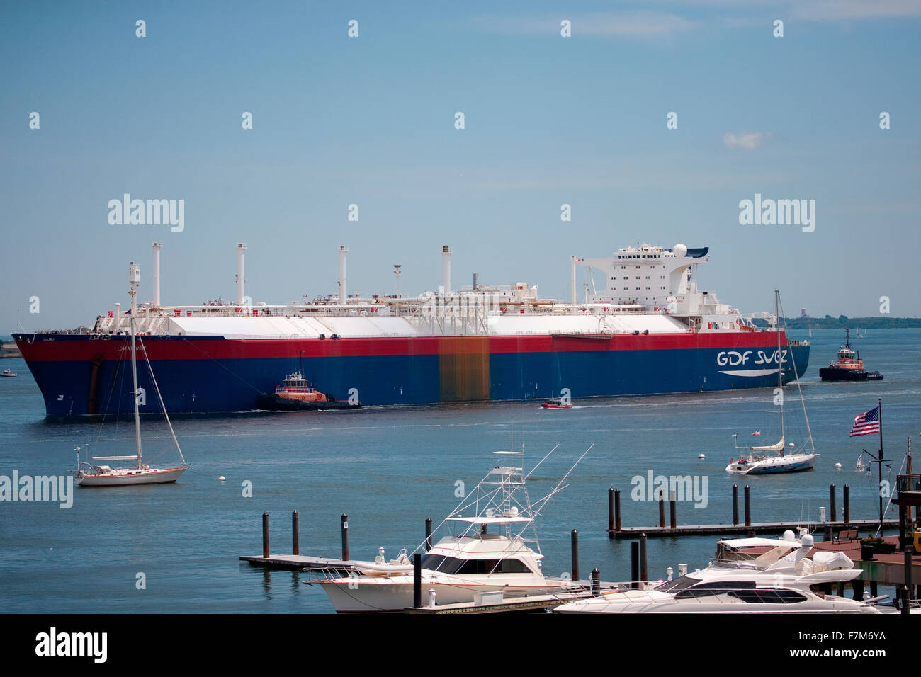 Ocean Freighter enters Boston Harbor with tug boats, Boston, MA Stock Photo