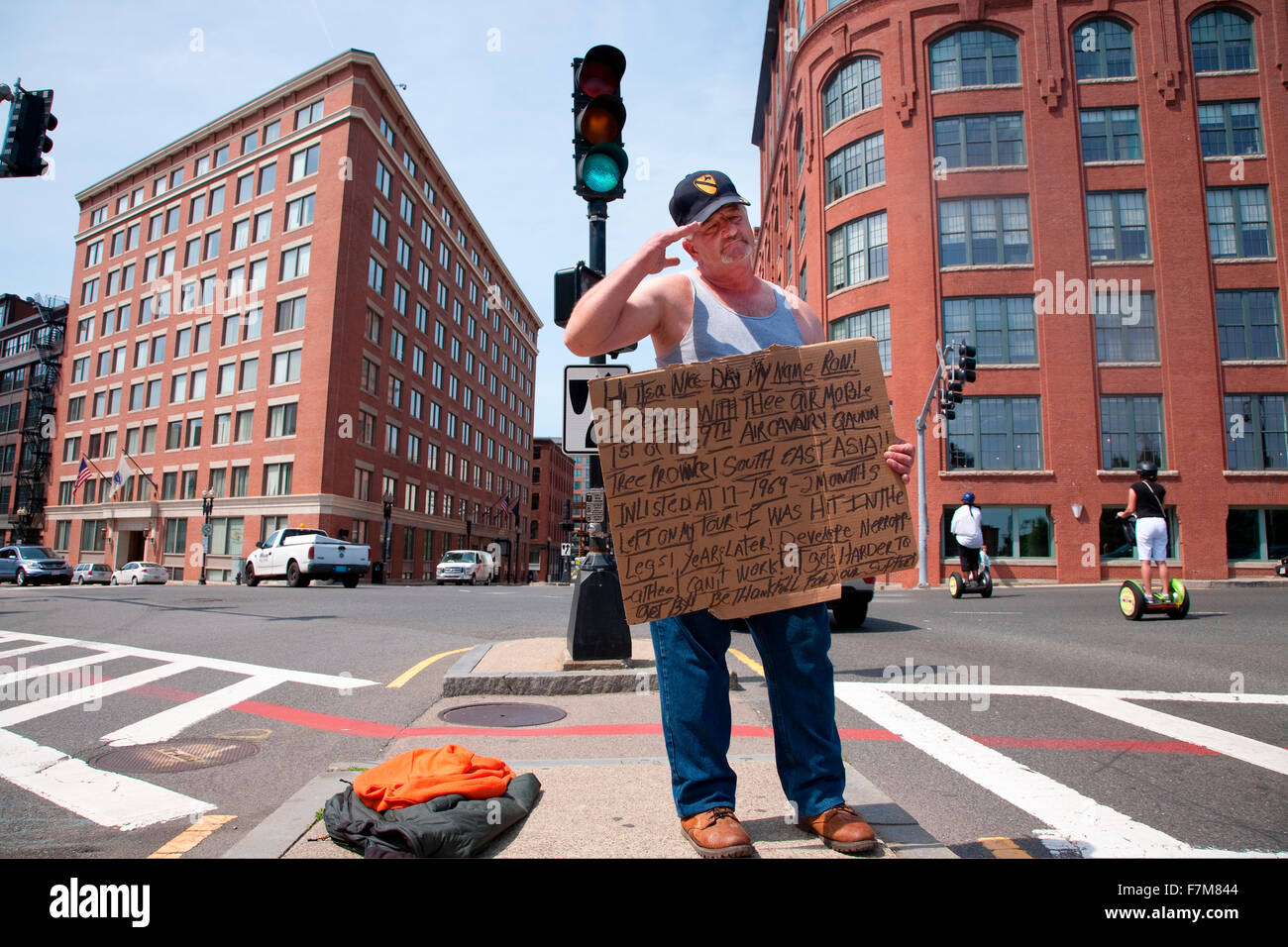 Vietnam War veteran salutes passerbys as he panhandles for money on streets of Boston, MA Stock Photo