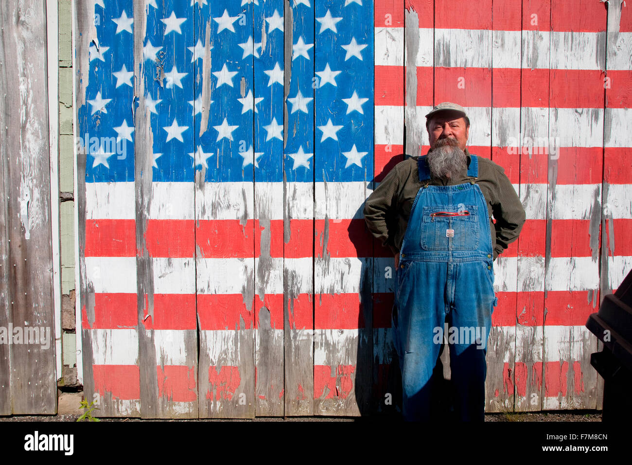 Howard the teacher poses in front of US flag on his shed, near Augusta, Maine Stock Photo
