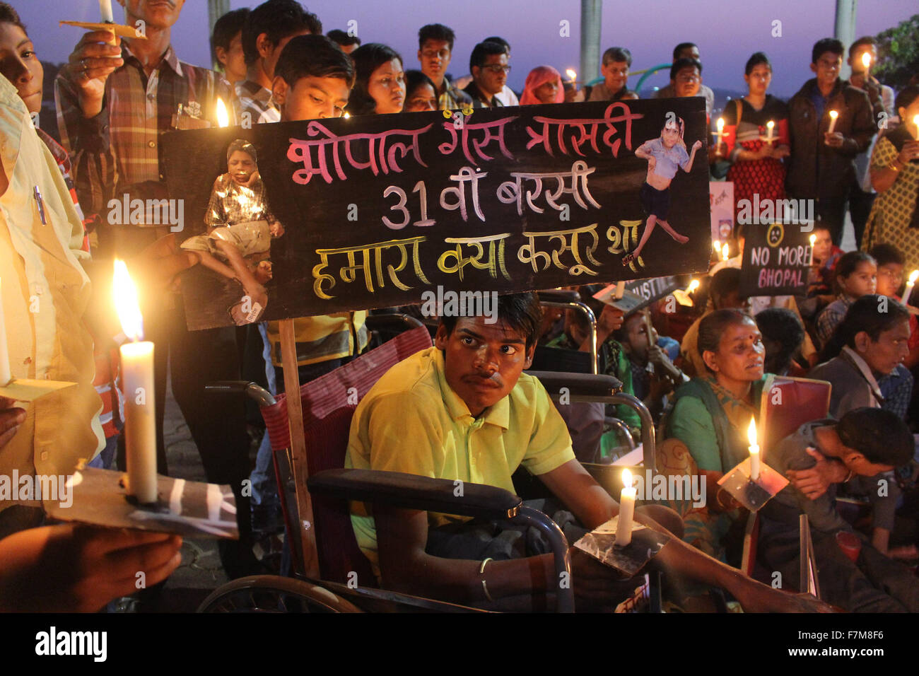 Bhopal, India. 1st Dec, 2015. Survivors' descendants with congenital disabilities light candles during a vigil marking the 31st anniversary of the gas tragedy in Bhopal, India, Dec. 1, 2015. More than 15,000 residents were killed by the gas leakage from the Union Carbide pesticide plant on the night of Dec. 2 to 3, 1984 in Bhopal, considered the world's worst industrial disaster. © Stringer/Xinhua/Alamy Live News Stock Photo
