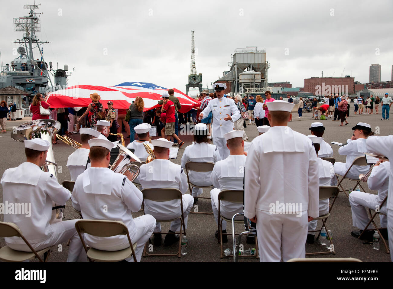 US Navy Band plays in front of US Flag for Bicentennial of War of 1812 which also feaures Canadian and British flag, USS Constitution Ship and Museum, Freedom Trail, Charlestown, Boston, MA Stock Photo