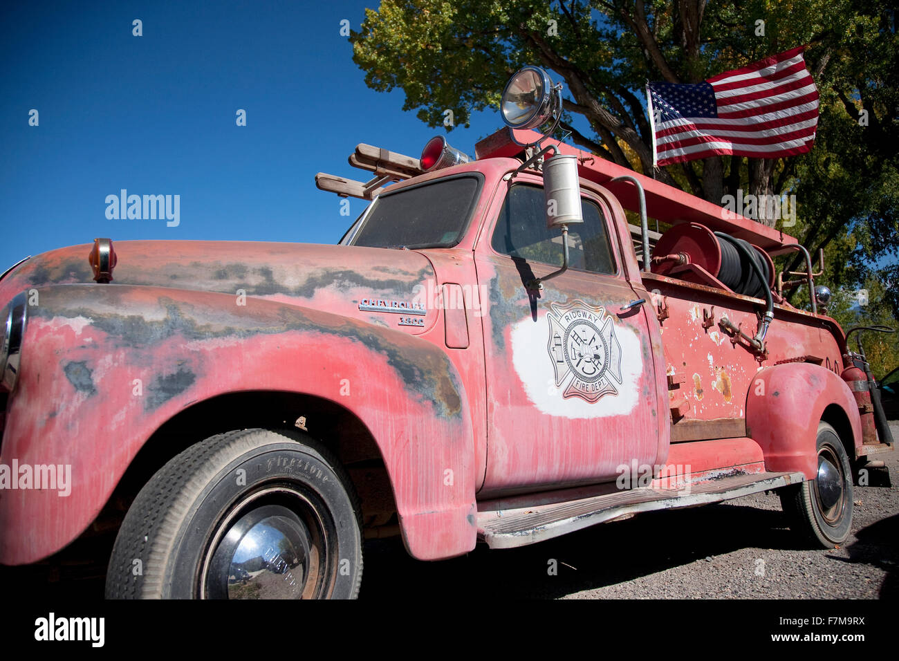 Red antique firetruck with American flag in Ridgeway Colorado Stock Photo
