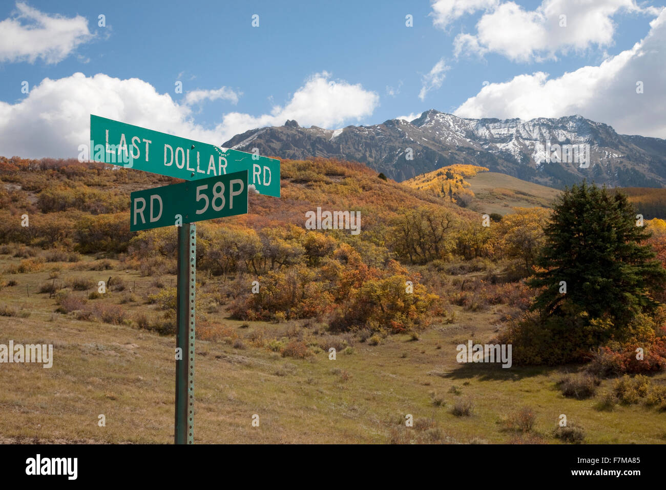 Road sign for 'Last Dollar Road' and San Juan Mountains, Ridgeway, CO Stock Photo