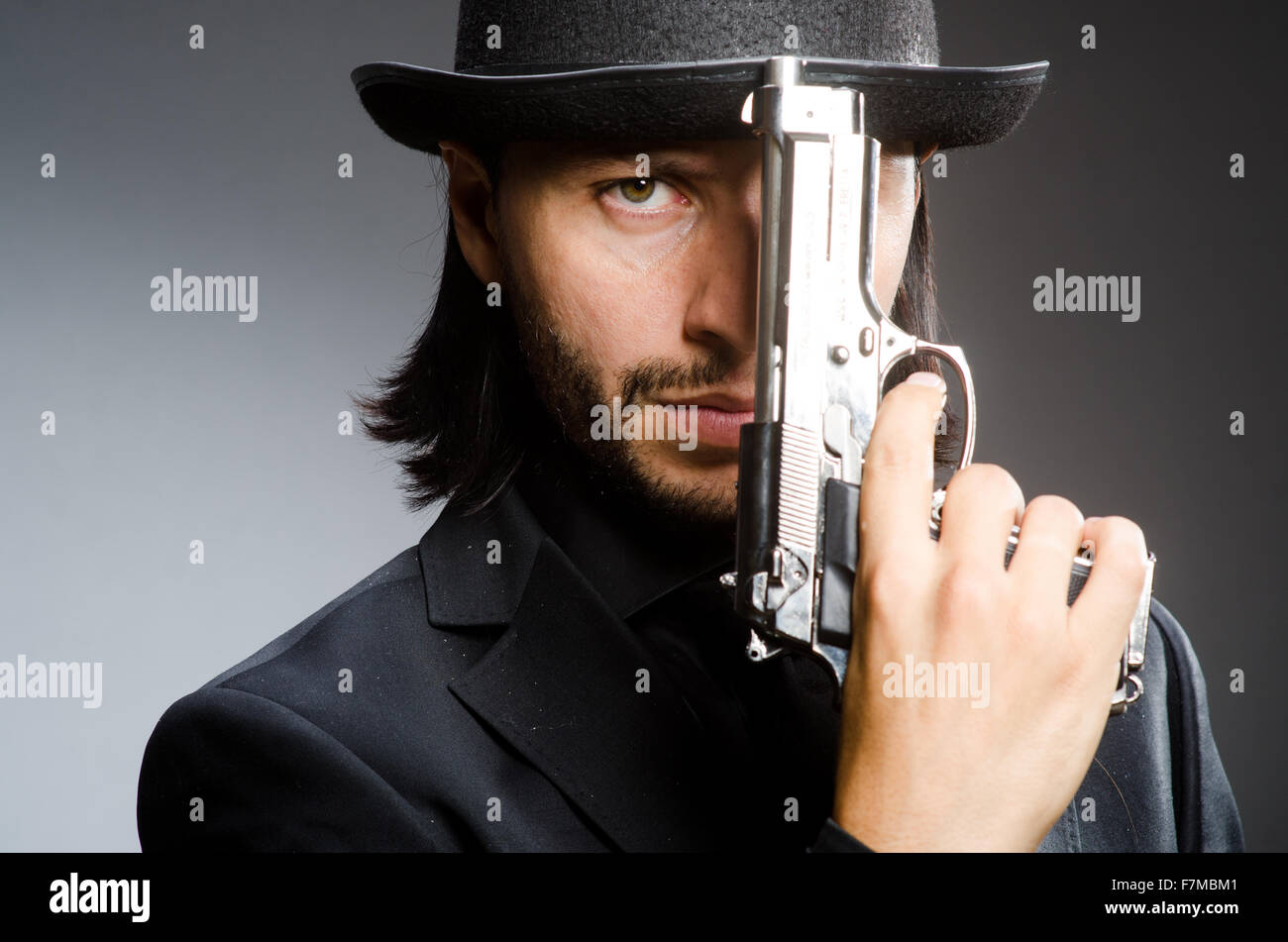 Man wearing vintage hat with gun Stock Photo Alamy