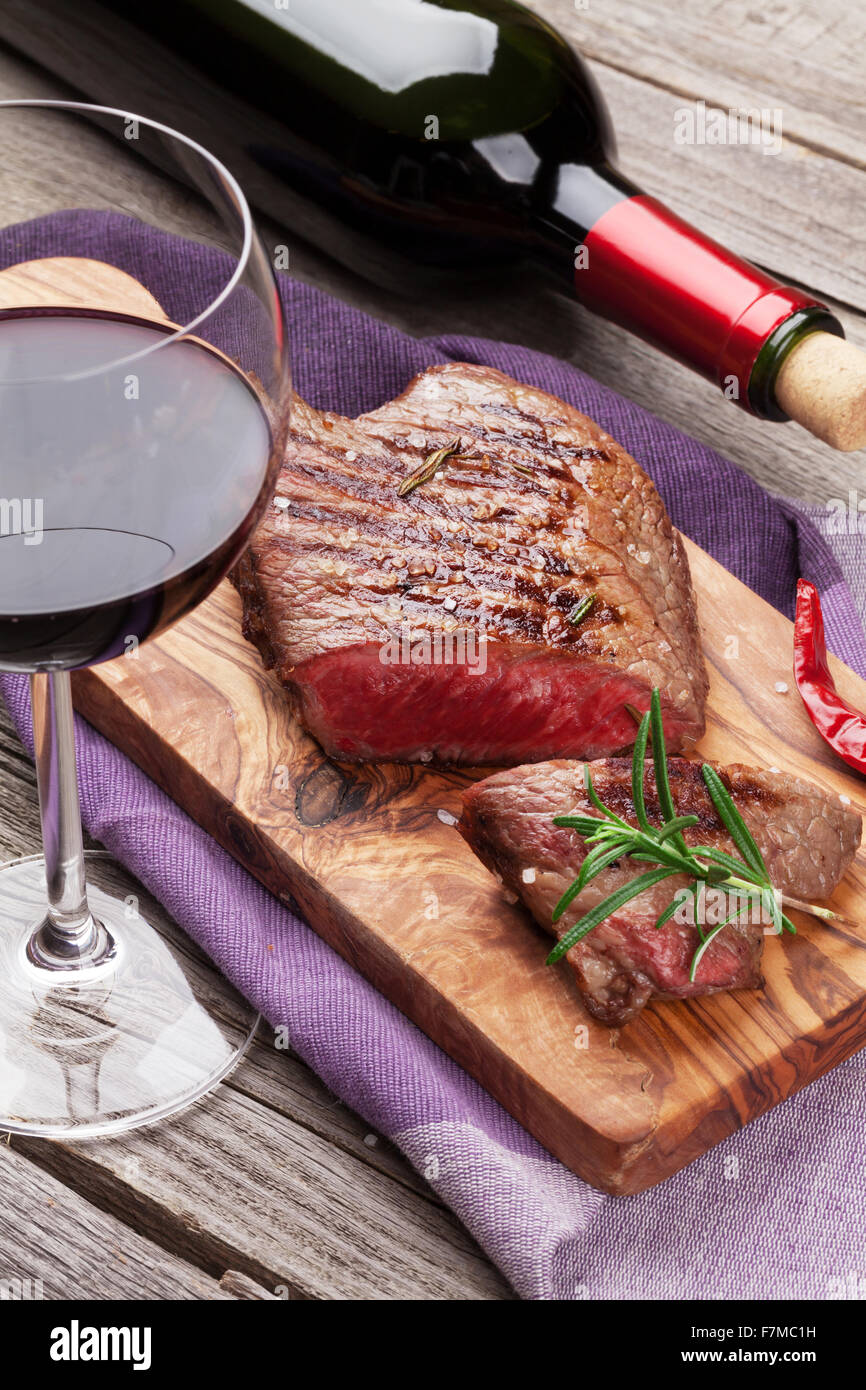 Grilled beef steak and red wine on wooden table Stock Photo Alamy