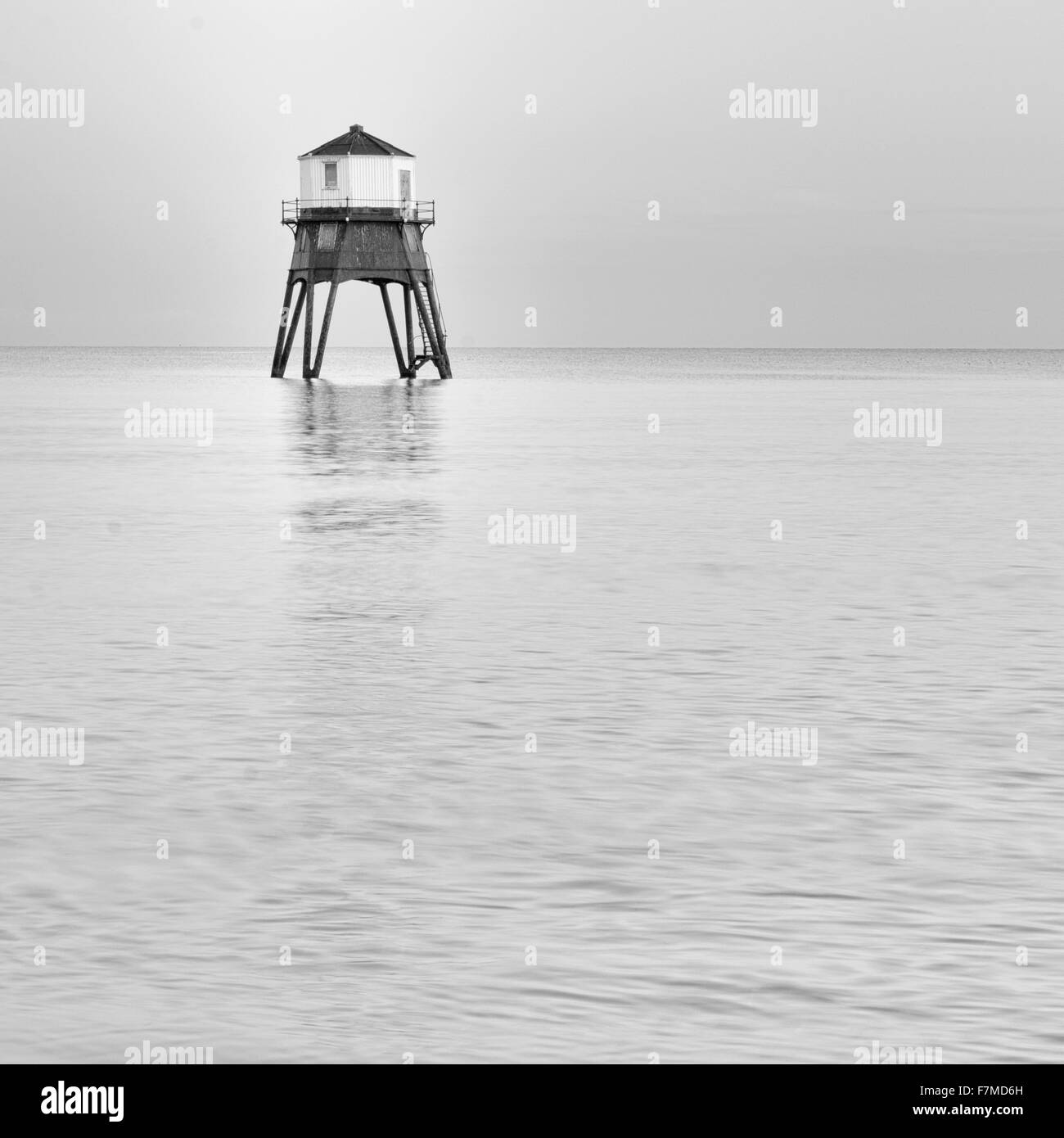 Dovercourt restored Lighthouse at Dovercourt, near Harwich, Essex at high tide, during the Winter solstice. Stock Photo