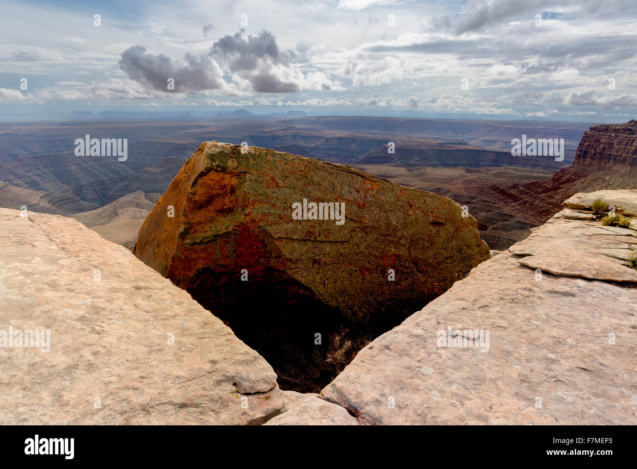 The rim of Cedar Mesa, Utah, with the San Juan River Canyon and Monument Valley Arizona in the background. Stock Photo