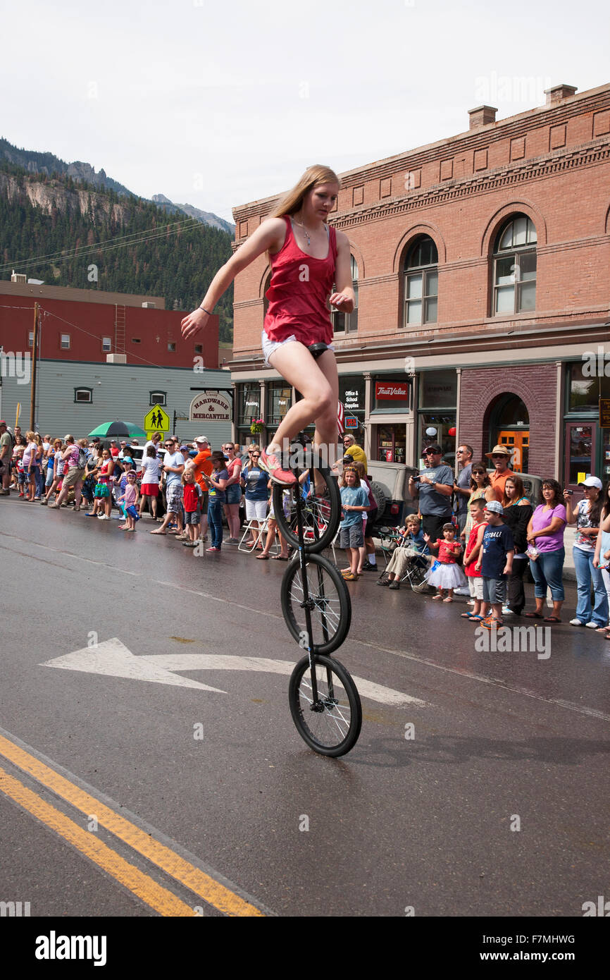 Unicyclist bicycles in July 4 Independence Day Parade, Ouray, Colorado
