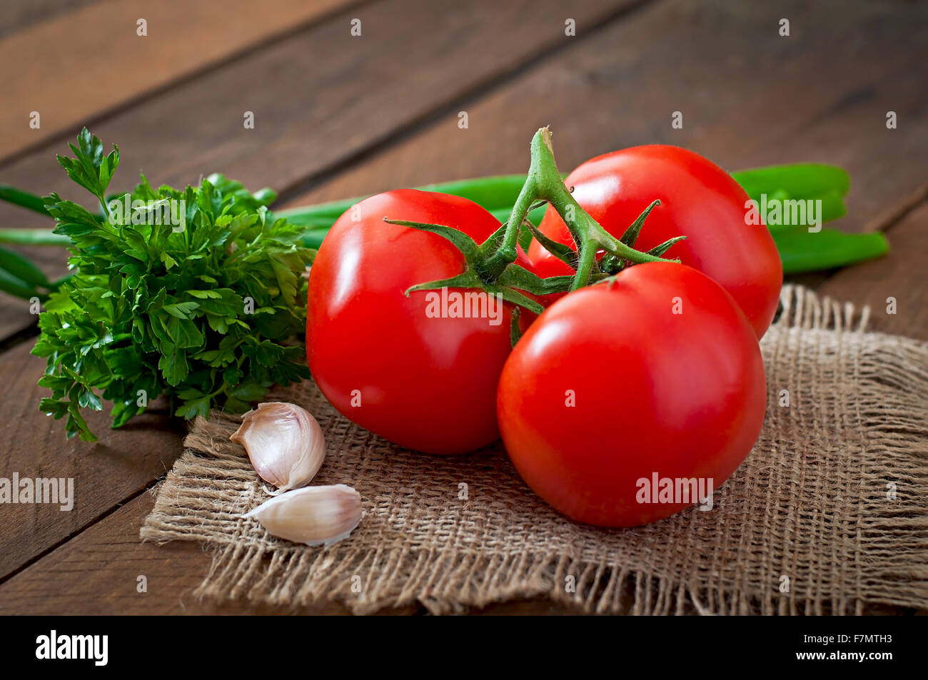 Branch of fresh tomato on wooden background Stock Photo - Alamy