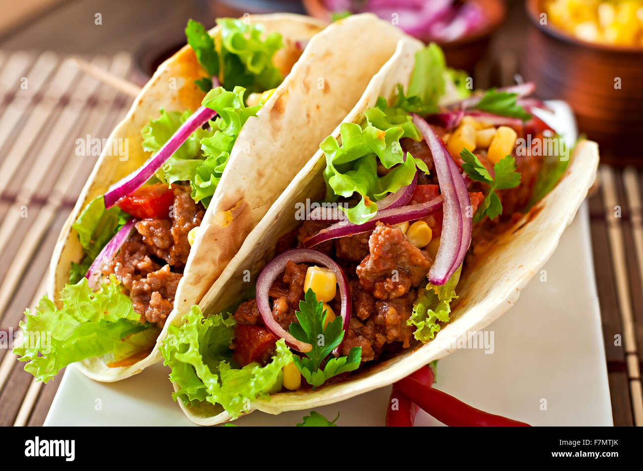 Taco Description Mexican tacos with meat, vegetables and red onion Stock Photo - Alamy