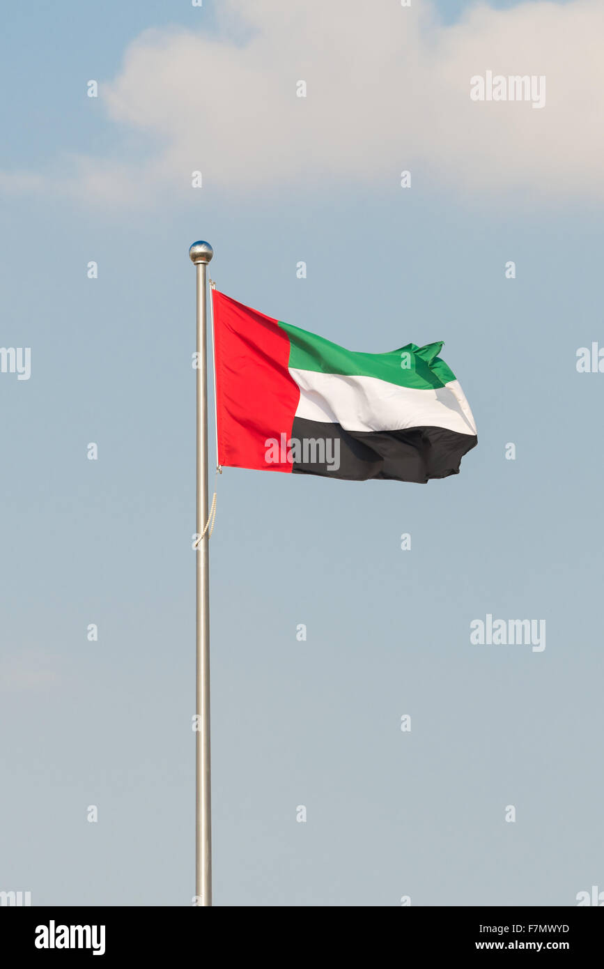 Flag of the United Arab Emirates flying from a pole Stock Photo