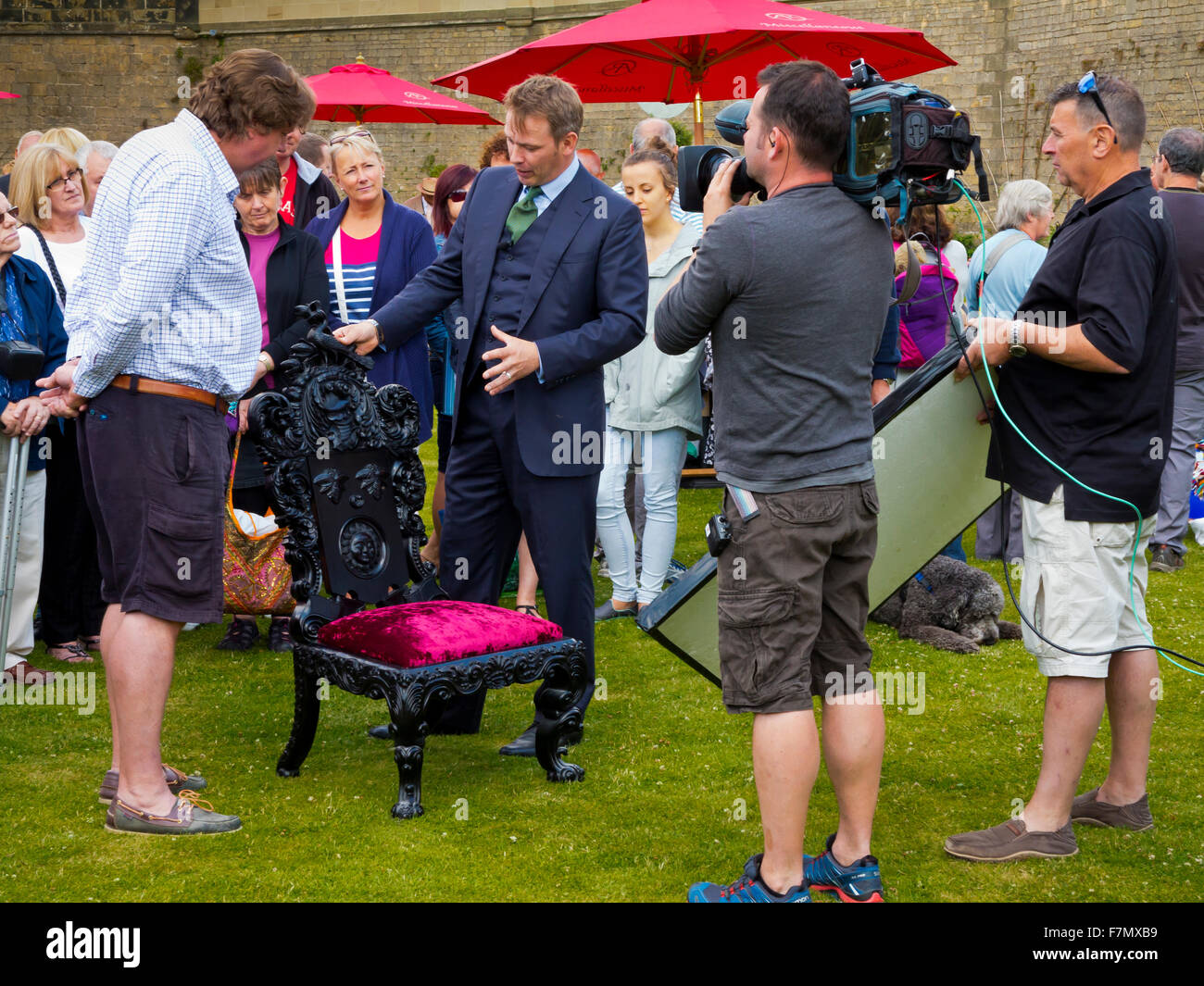 Expert looking at a chair during filming of BBC Antiques Roadshow tv