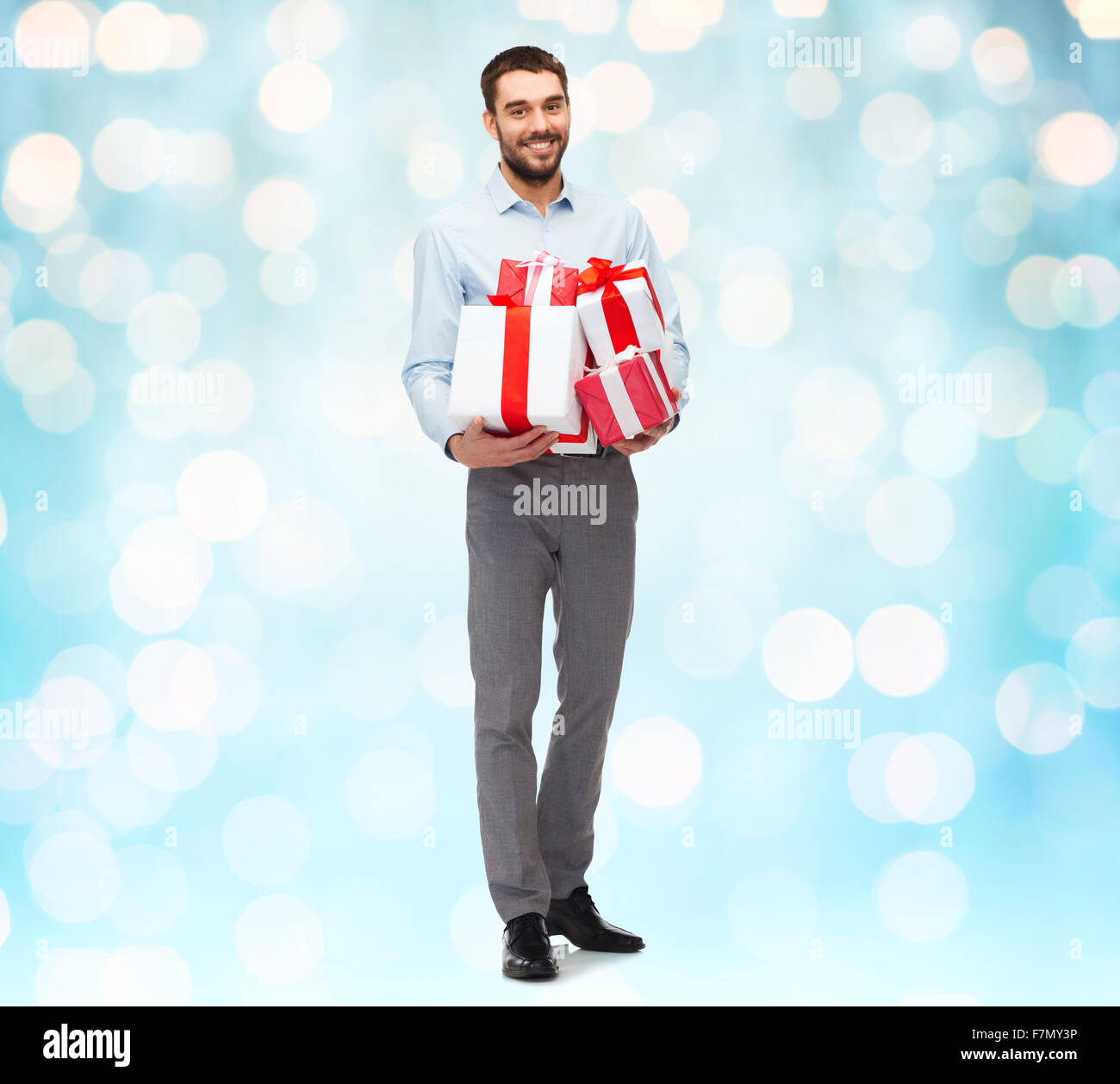 happy young man holding gift boxes Stock Photo