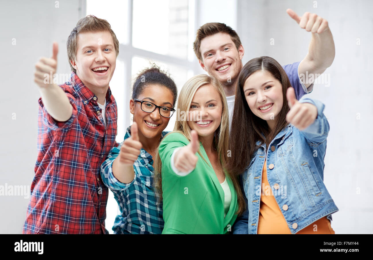 group of happy students showing thumbs up Stock Photo - Alamy