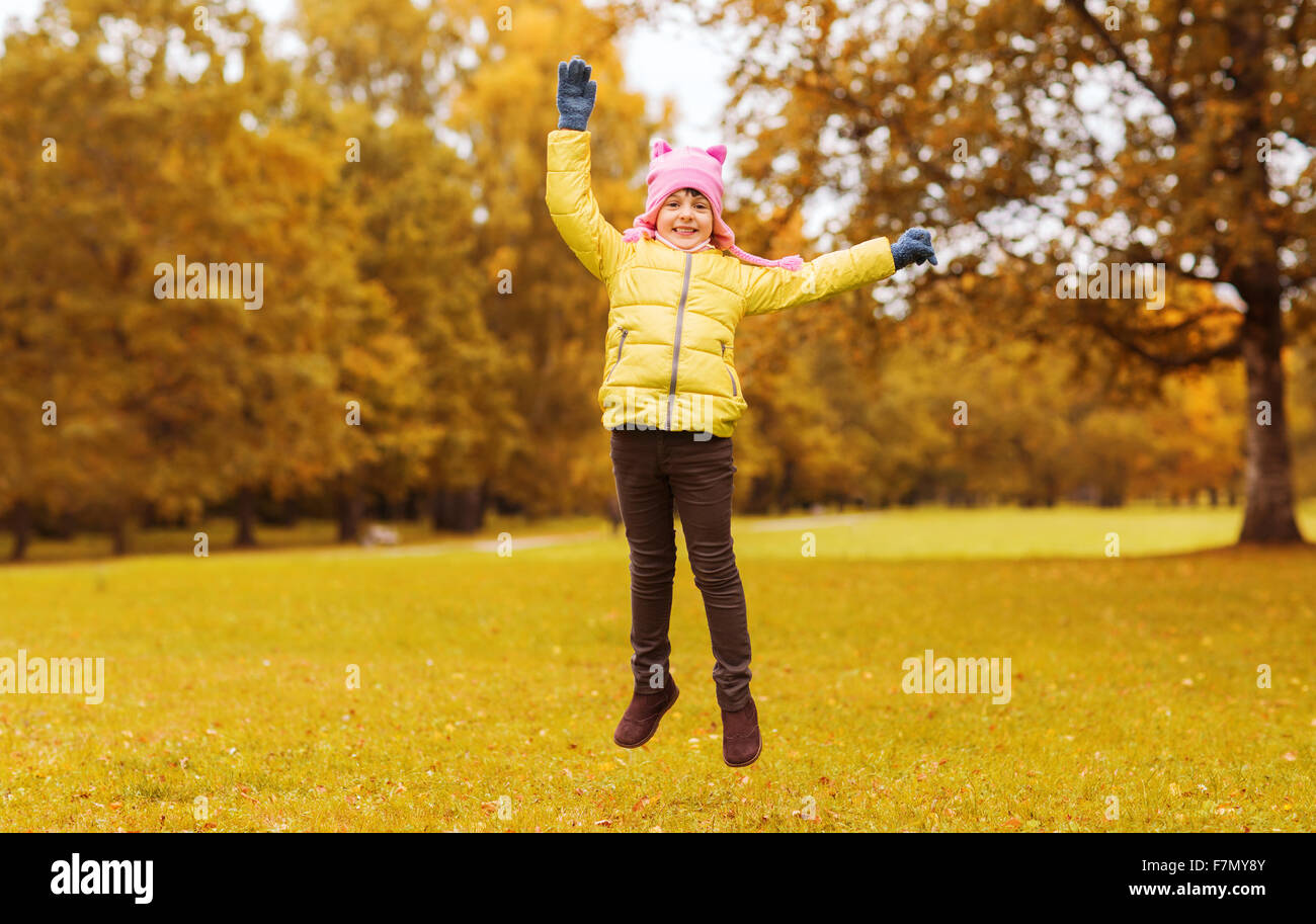 happy little girl jumping outdoors Stock Photo - Alamy
